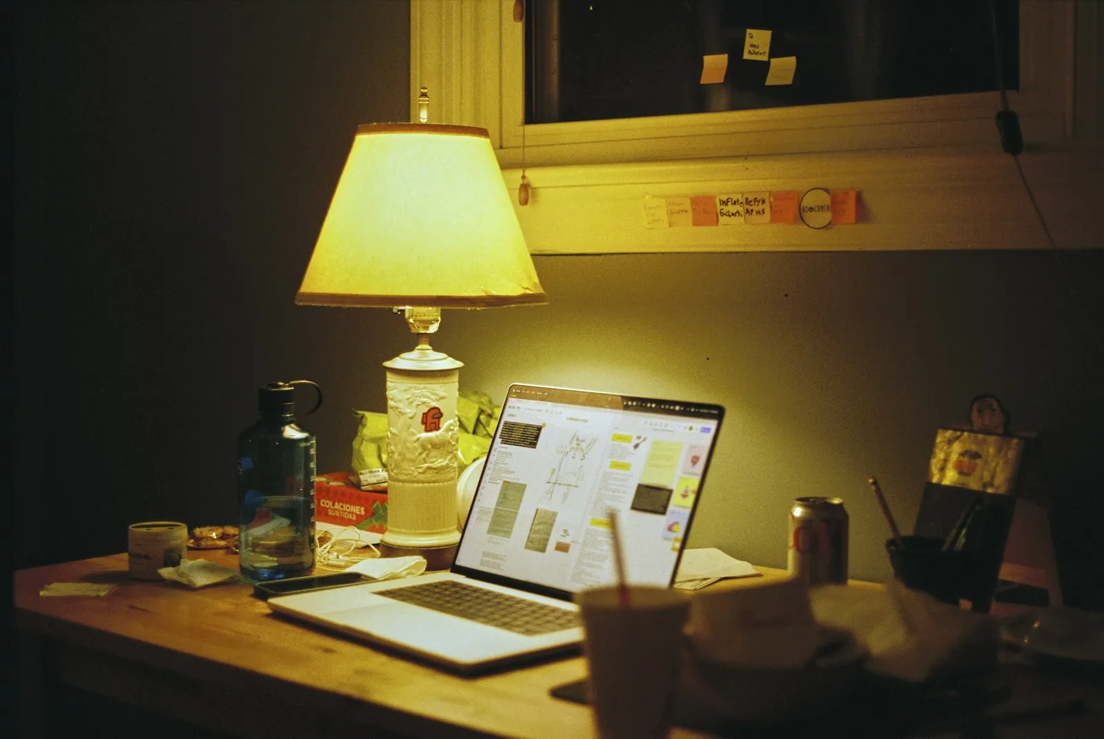 A desk lamp over an evening's work A desk lamp over an evening's work
