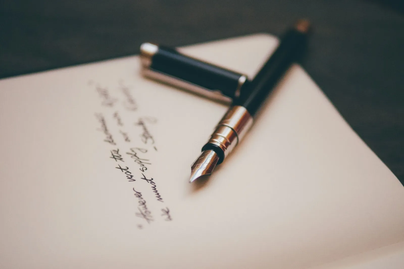 A fountain pen resting on a desk