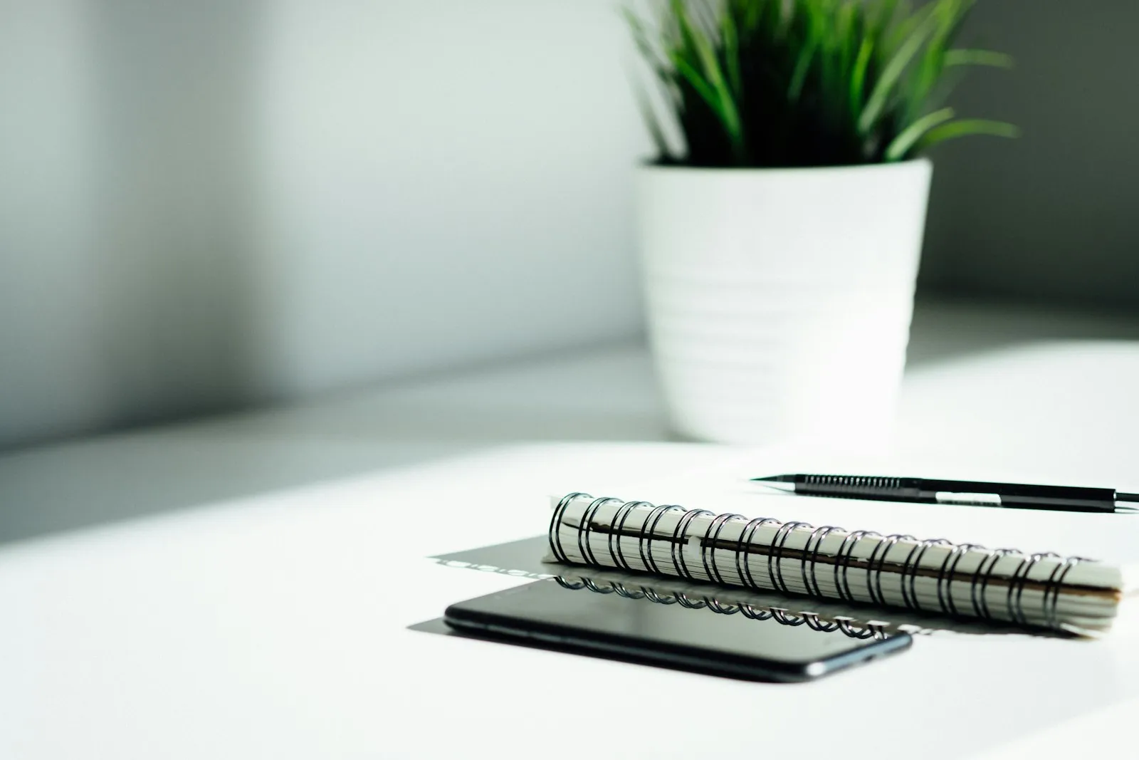 A pen and notebook laid out on a table